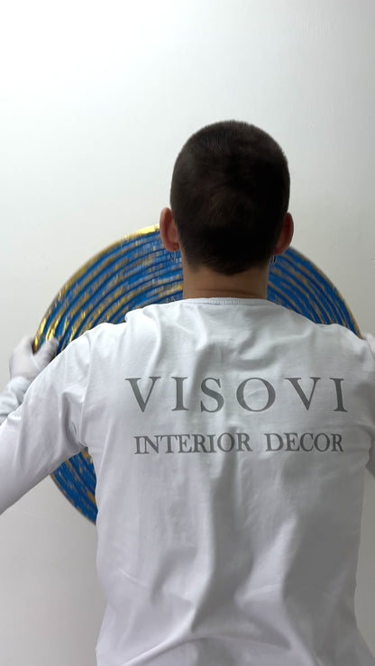 Textured 3D spiral wall panel in prime blue with gold leaf shown in motion and lighting
