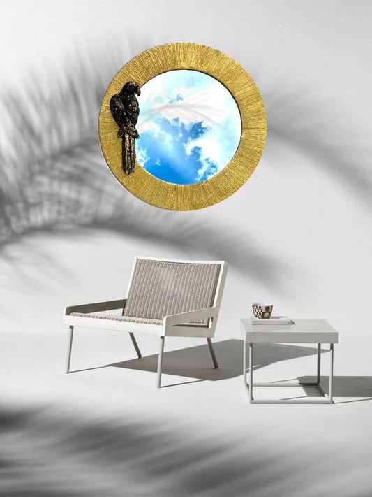 Luxury round gold mirror with black parrot accent for interiors, hotels and boutique spaces